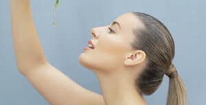 Profile view of a woman looking upward, showcasing smooth skin and natural beauty.