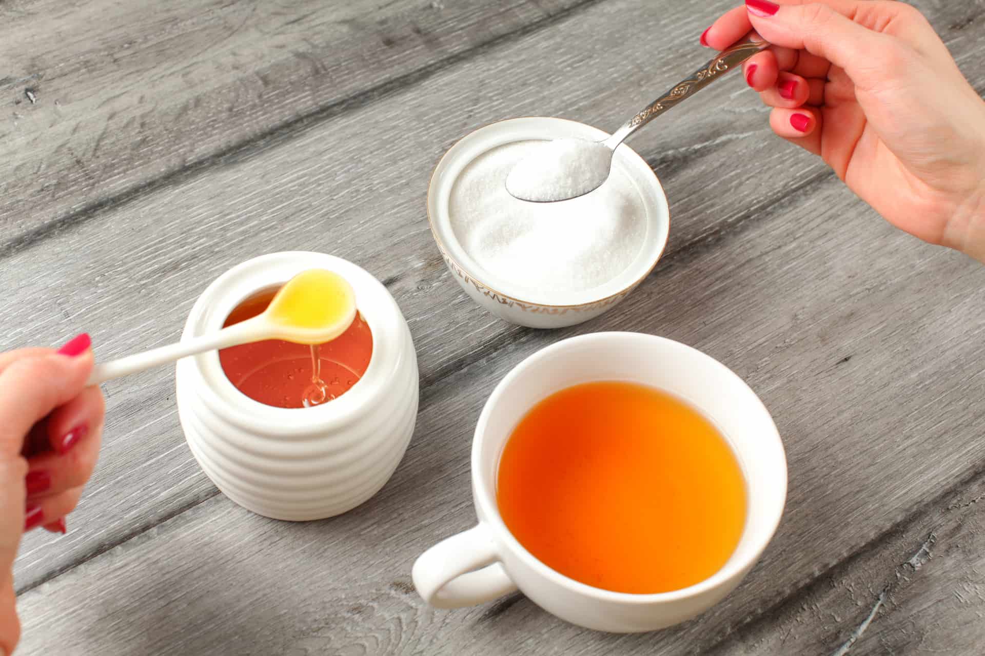 Tea with honey and sugar on a wooden table