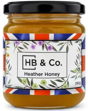 Jar of HoneyBee & Co. Heather Honey 280g with a deep amber colour and floral Union Jack label design.