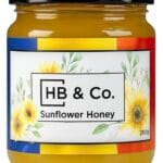 Jar of HoneyBee & Co. Sunflower Honey 280g with a bright golden colour and floral Union Jack label design.
