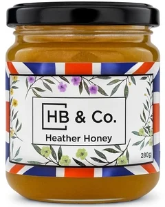 Jar of HoneyBee & Co. Heather Honey 280g with a deep amber colour and floral Union Jack label design.