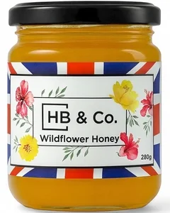Jar of HoneyBee & Co. Wildflower Honey 280g with a golden amber colour and floral Union Jack label design.