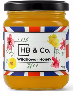Vasetto di miele millefiori HoneyBee & Co. da 280 g, di colore ambrato e con etichetta floreale Union Jack.