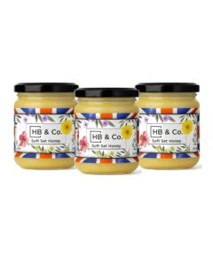 Soft Set Honey in glass jars with floral labels and black lids.