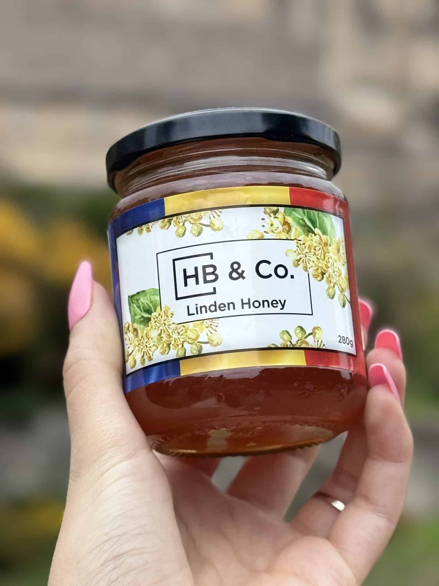 Morning ritual with raw Linden honey, herbal tea on a wooden table