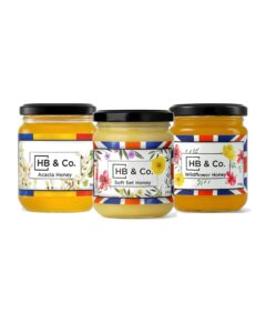 Assorted Honey Jars from HoneyBee & Co. with floral labels.